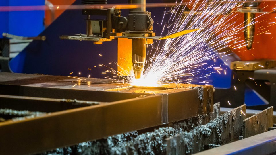 A closeup shot of sparks flying from an industrial steel cutter